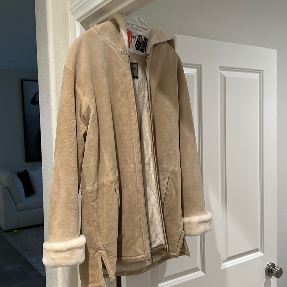 Heavy leather winter jacket, dry cleaned. Tan and off white fur on the inside